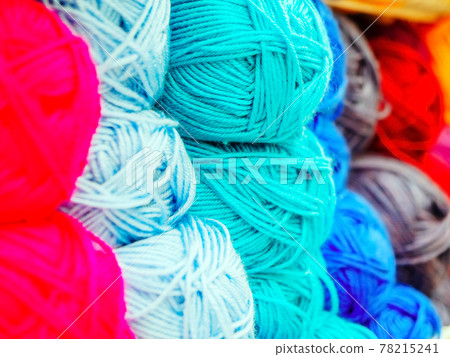 Skeins of woolen yarn of different colors. Full screen photo with center focus. Shop counter Skeins of woolen yarn of different colors. Full screen photo with center focus. Shop counter 78215241