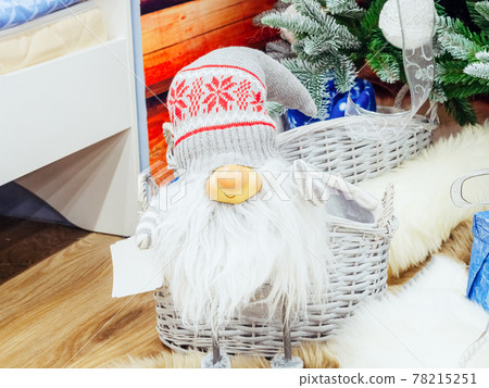 Little elf in a gray cap and with a fluffy beard 78215251