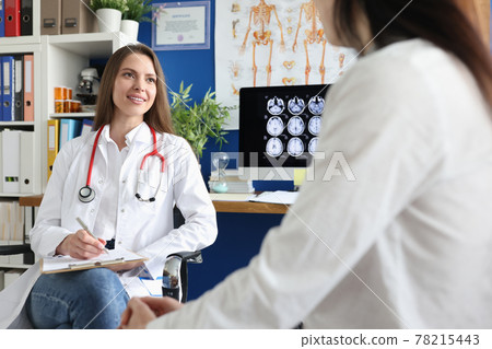 Female doctor conducts medina patient appointment in office Female doctor conducts medina patient appointment in office 78215443