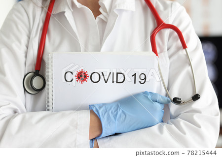 Gloved doctor holds documents with statistics of cases of coronavirus infection Gloved doctor holds documents with statistics of cases of coronavirus infection 78215444