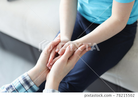 Palms of mother and girl are joined together 78215502