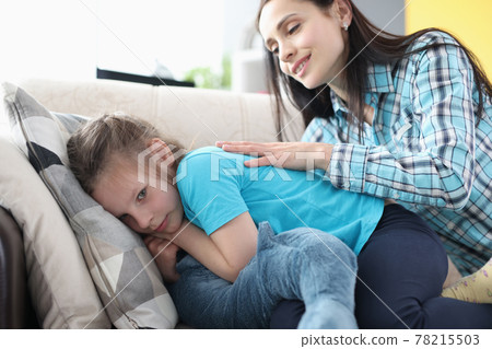 Offended little girl turned away from her mother on couch Offended little girl turned away from her mother on couch 78215503