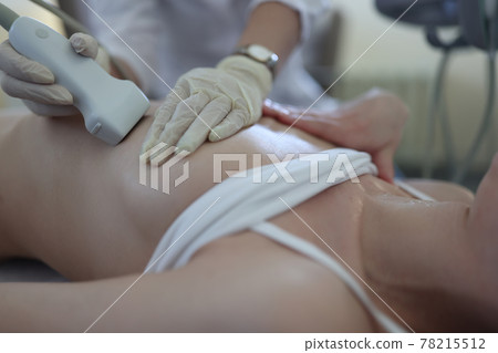 Uzist doctor conducts medical examination of mammary glands of woman 78215512