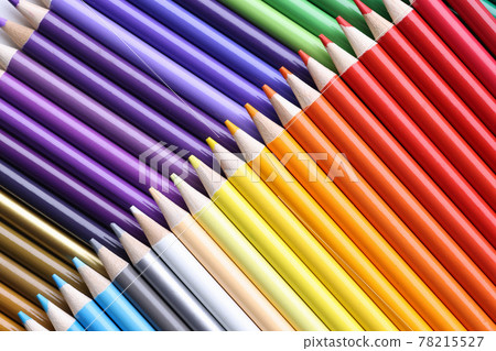 Set of multi-colored pencils lie on table 78215527