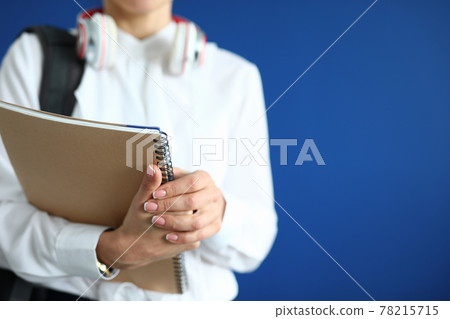 Silhouette of woman with backpack and headphones in hands of notebook 78215715