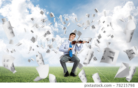 young businessman playing violin young businessman playing violin 78215798