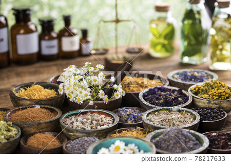 Natural remedy and wooden table background Natural remedy and wooden table background 78217633