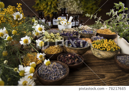 Homeopathy, herbal medicine on wooden table Homeopathy, herbal medicine on wooden table 78217685