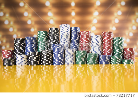 Poker Chips on gaming table 78217717