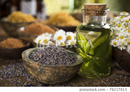 Natural remedy and mortar, healing herbs background Natural remedy and mortar, healing herbs background 78217813