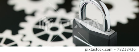 Black metal padlock standing on tablet screen closeup 78218436