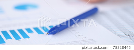 Ballpoint pen lying on documents with graphs and diagrams closeup 78218445