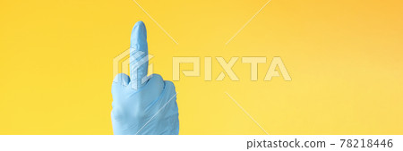 Hand in rubber glove showing middle finger closeup Hand in rubber glove showing middle finger closeup 78218446