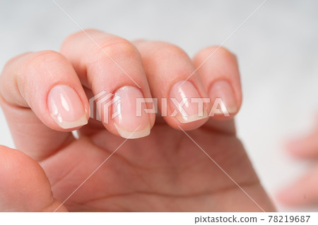Woman in a nail salon receiving a manicure by a beautician with nail file. Beauty and hand care close-up. 78219687