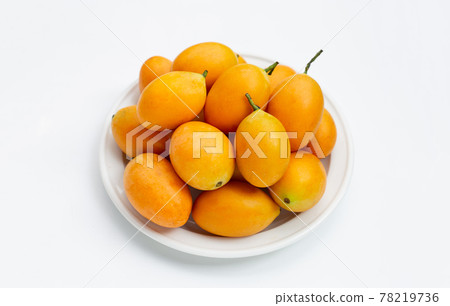 Marian plum fruit in white plate on white background. Marian plum fruit in white plate on white background. 78219736