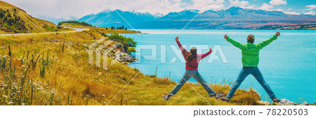 Happy excited couple jumping of joy on New Zealand Adventure Travel Vacation Concept. People in nature landscape South Island, by Aoraki aka Mount Cook. Panoramic banner Happy excited couple jumping of joy on New Zealand Adventure Travel Vacation Concept. People in nature landscape South Island, by Aoraki aka Mount Cook. Panoramic banner 78220503
