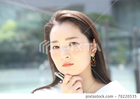 A woman with a beautiful suspicious face looking at the camera A woman with a beautiful suspicious face looking at the camera 78220535