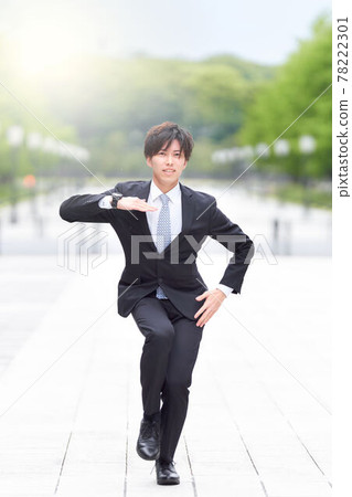 A young man in a suit dancing on the street A young man in a suit dancing on the street 78222301