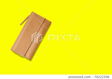 Fashionable leather women's wallet on a yellow background. added copy space for text. 78222306