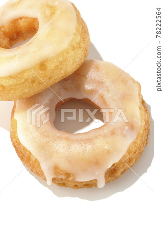 A bird's-eye view of two overlapping honey glaze donuts with summery light and a white background A bird's-eye view of two overlapping honey glaze donuts with summery light and a white background 78222564