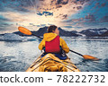 Woman paddle a canoe on an icy bay in Alaska exploring glaciers 78222732