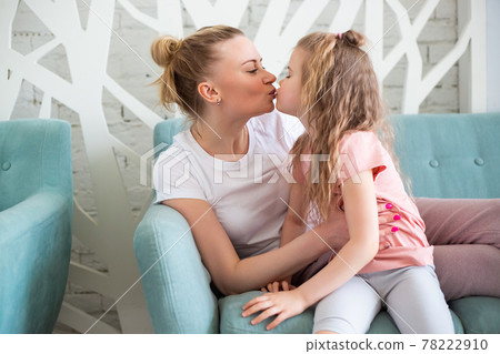 Little girl sitting with mother on sitting on the sofa in living room, Little girl sitting with mother on sitting on the sofa in living room, 78222910