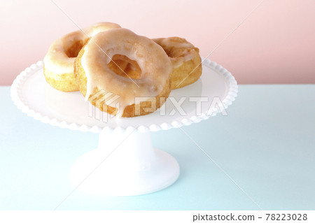 Honey glaze donuts served on a cake stand Honey glaze donuts served on a cake stand 78223028