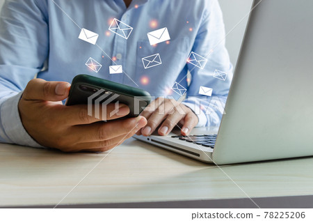 Close-up man holding a cell phone an icon email message. Marketing business sending information to customers or hacking online transactions. Business concept technology. Close-up man holding a cell phone an icon email message. Marketing business sending information to customers or hacking online transactions. Business concept technology. 78225206