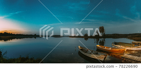 Real Starry Sky And Night Stars Above Lake. Natural Starry Sky Reflection Landscape Panorama Panoramic View 78226690