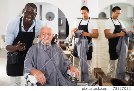 African hairdresser discussing haircut with elderly man African hairdresser discussing haircut with elderly man 78227023