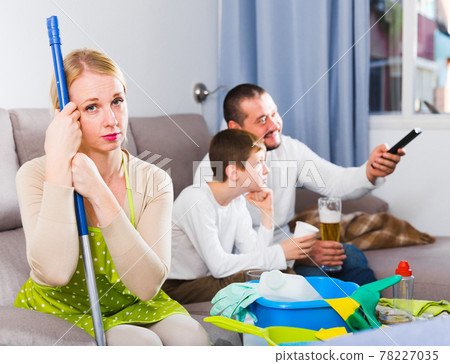 Upset woman with cleaning equipment 78227035