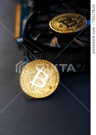 Bitcoin coin on a powerful graphics card for mining and earning cryptocurrency concept Bitcoin coin on a powerful graphics card for mining and earning cryptocurrency concept 78227626