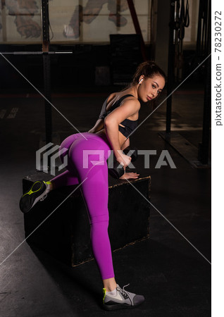 Young beautiful woman doing one-arm dumbbell back exercise on bench. Athletic girl in the gym. Exercises for the latissimus dorsi. Young beautiful woman doing one-arm dumbbell back exercise on bench. Athletic girl in the gym. Exercises for the latissimus dorsi. 78230272