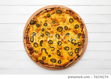 Whole round pizza topped with olives and cheese on wooden plate. Top view on white board background 78230274