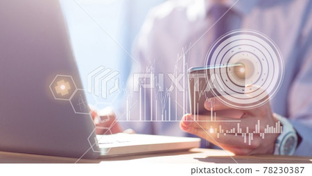 Composition of person at desk using laptop and smartphone, with research data interface screen 78230387