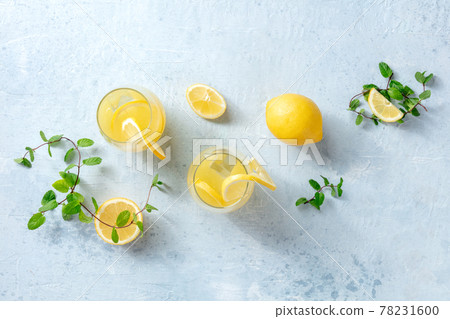 Lemonade. Homemade fresh drink with lemon and mint, overhead flat lay Lemonade. Homemade fresh drink with lemon and mint, overhead flat lay 78231600