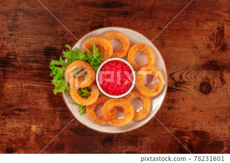 Squid rings. Deep fried calamari rings with lettuce and ketchup Squid rings. Deep fried calamari rings with lettuce and ketchup 78231601