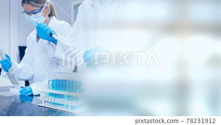 Composition of male and female lab technicians at work, with blurred copy space to right 78231912