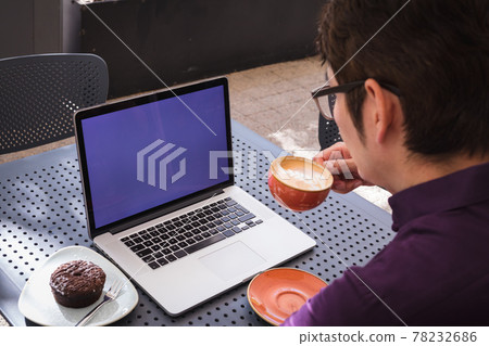 Asian businessman using laptop with blank screen drinking coffee in cafe Asian businessman using laptop with blank screen drinking coffee in cafe 78232686