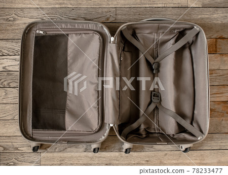 Open suitcase isolated on old wooden background Open suitcase isolated on old wooden background 78233477