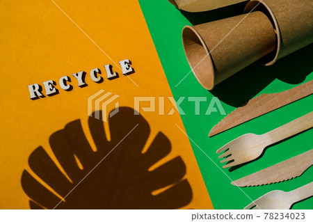 RECYCLE text Wooden forks and paper cups with plates on color background. Eco friendly disposable tableware. Used in fast food, restaurants, takeaways, picnics. No plastic RECYCLE text Wooden forks and paper cups with plates on color background. Eco friendly disposable tableware. Used in fast food, restaurants, takeaways, picnics. No plastic 78234023