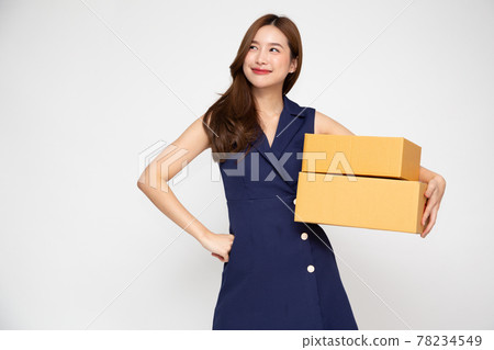 Happy Asian woman smiling and holding package parcel box isolated on white background, Delivery courier and shipping service concept 78234549