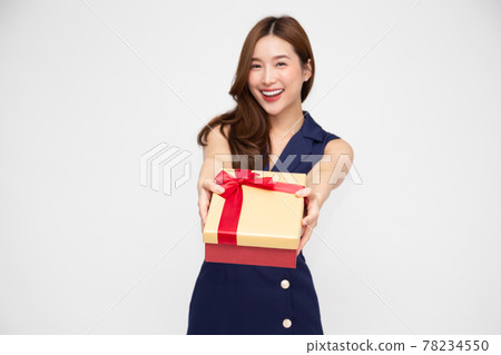Happy beautiful Asian woman smile with gold gift box isolated on white background. Teenage girls in love, Receiving gifts from lovers. New Year, Christmas and Valentines Day concept, Focus box 78234550