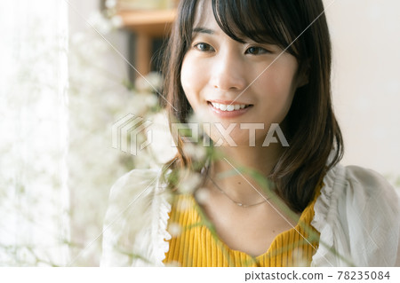A woman with a flower arrangement A woman with a flower arrangement 78235084