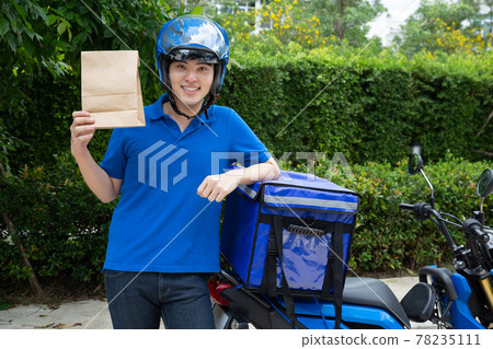 Young Asian man with delivery box, Motorcycle delivering food express service concept. Young Asian man with delivery box, Motorcycle delivering food express service concept. 78235111