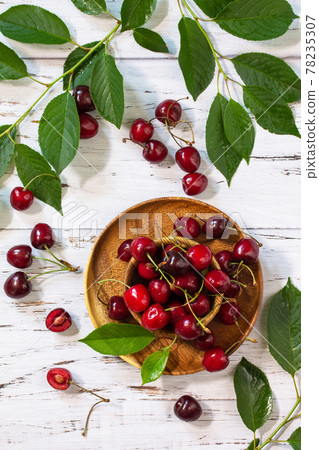 Juicy berry cherry in a bowl on a kitchen rustic table. Top view flat lay background. 78235307