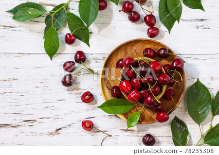 Juicy berry cherry in a bowl on a kitchen rustic table. Top view flat lay background. Copy space. 78235308