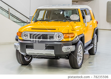 Large yellow SUV exhibited in the showroom Large yellow SUV exhibited in the showroom 78235506