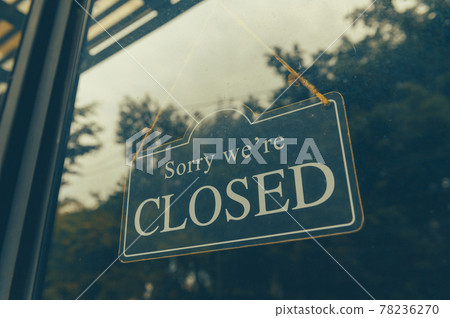 SORRY WE ARE CLOSED - Close sign broad hanging front of entrance door with copy space at coffee shop or restaurant 78236270