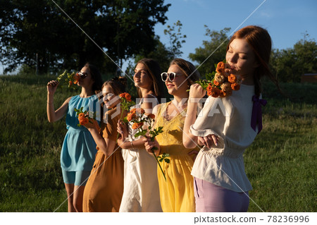 Group of happy young women, female friends having fun on summer nature background. Many young female friends together looking the sunset. Female Friendship and Forever friends concept Group of happy young women, female friends having fun on summer nature background. Many young female friends together looking the sunset. Female Friendship and Forever friends concept 78236996